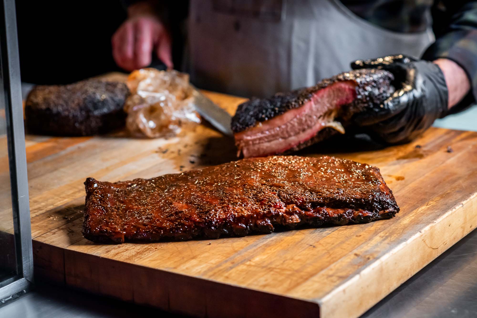 hands cutting ribs on cutting board